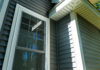 New vinyl siding and window treatments at a residential home.