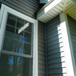New vinyl siding and window treatments at a residential home.